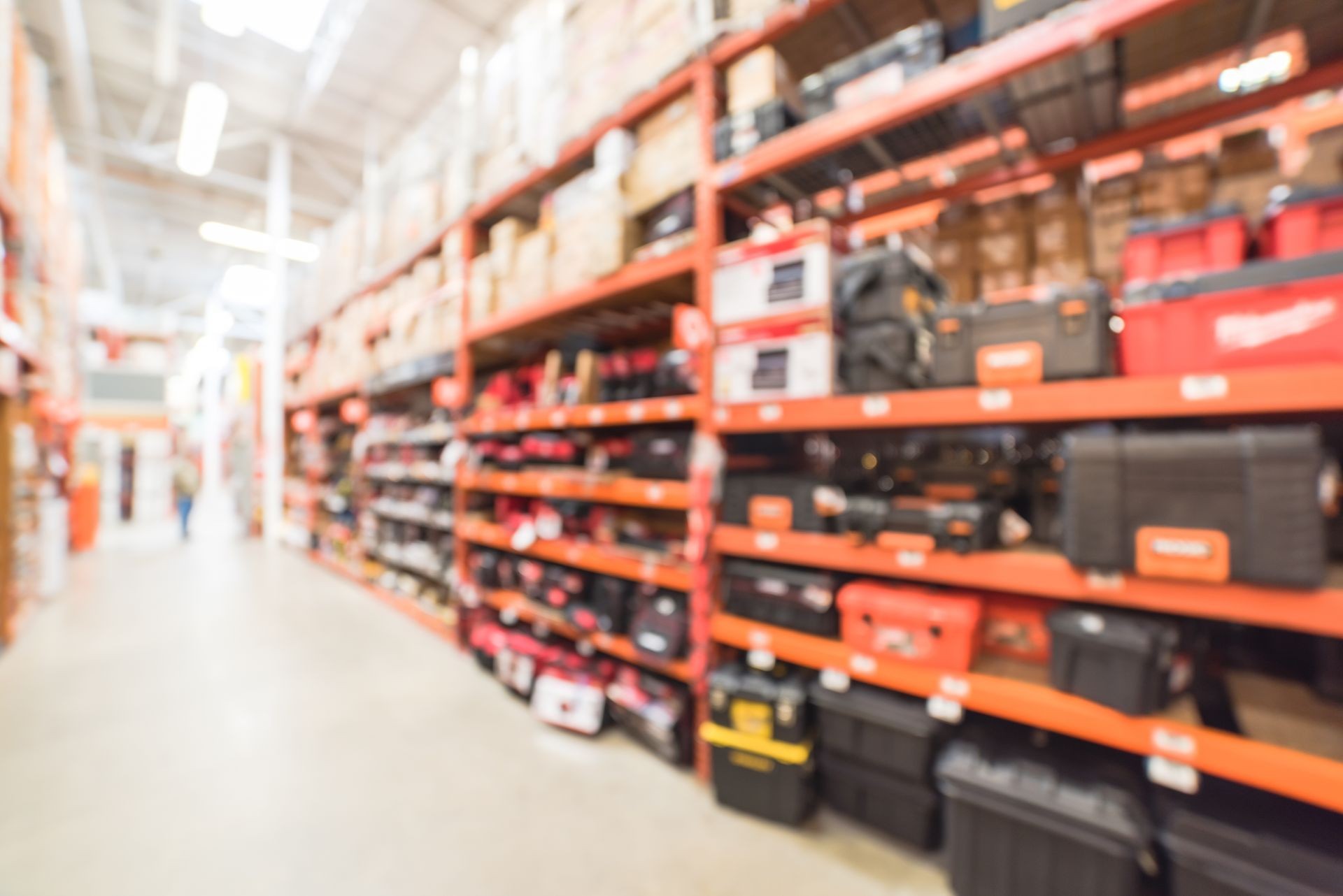 Blur hardware store in America. Defocused home improvement retailer, rack of drywall tools, join compound, rebar, deck boards, stair parts, wet/dry vacuums, tool boxes, child safety, building material