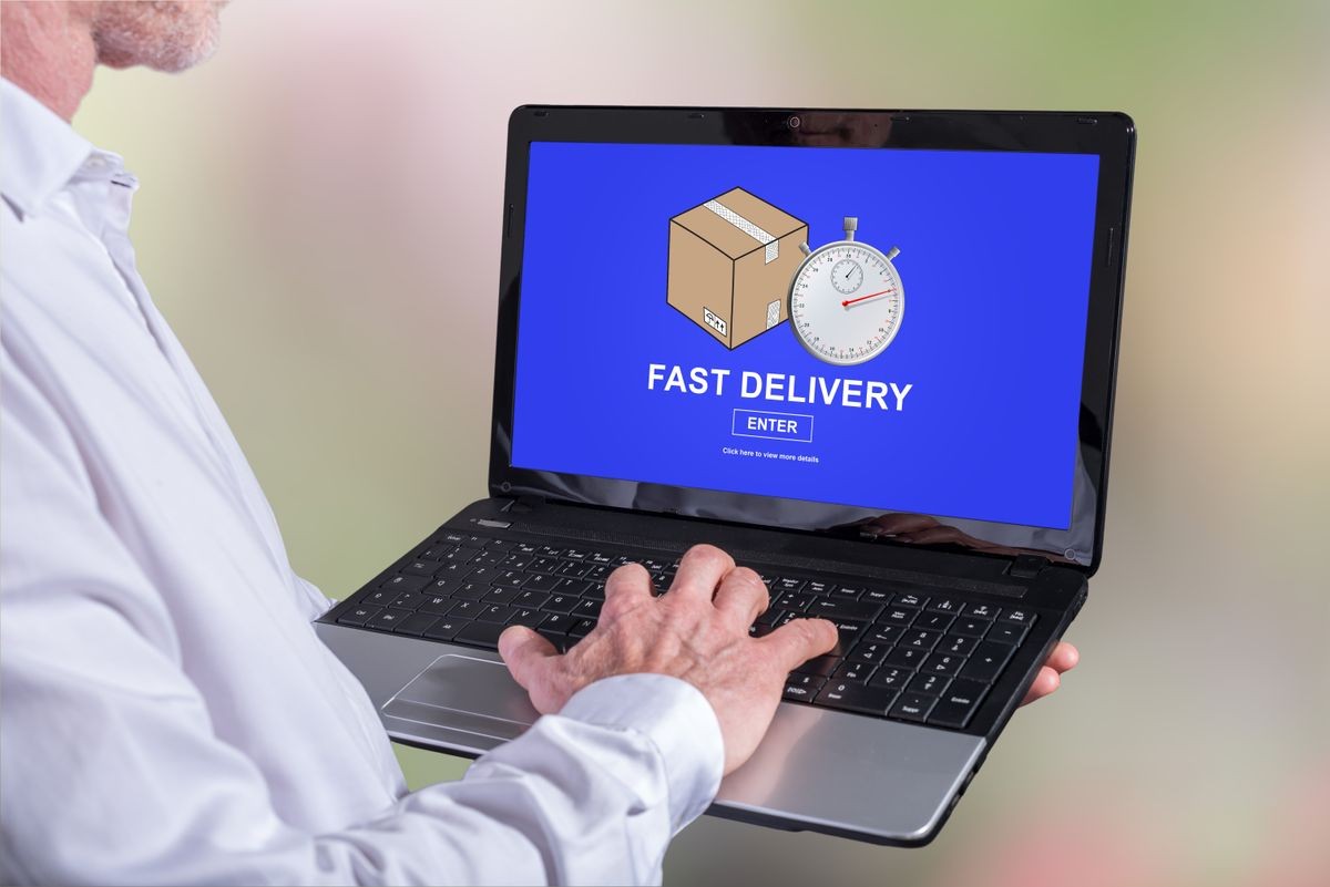Man using a laptop with fast delivery concept on the screen Man using a laptop with fast delivery concept on the screen